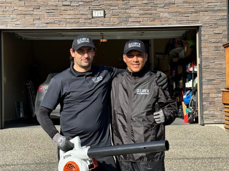 Jorge and a Cleany X teammate in front of a client garage